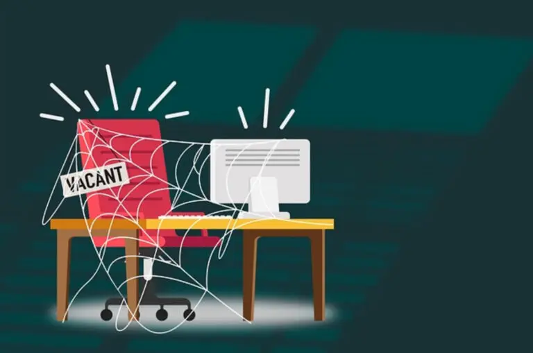 A spider web on a desk with a computer