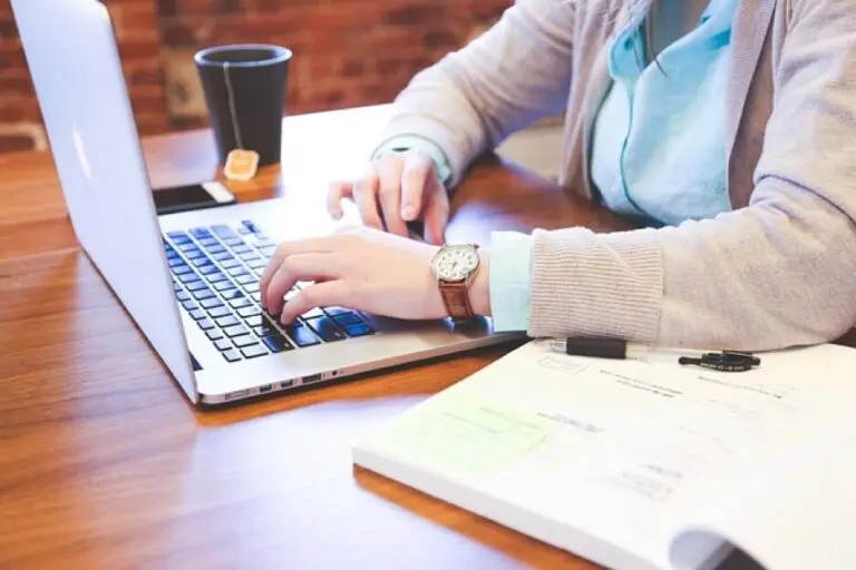 A woman typing on her laptop at a desk